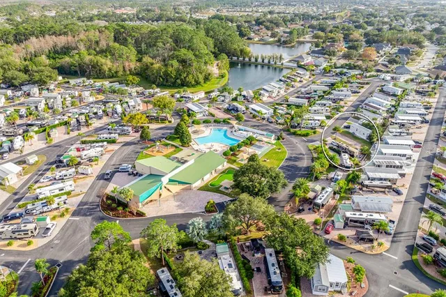 an aerial view of residential houses with outdoor space and swimming pool