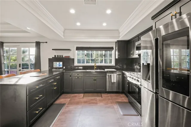 a kitchen with a sink cabinets and stainless steel appliances