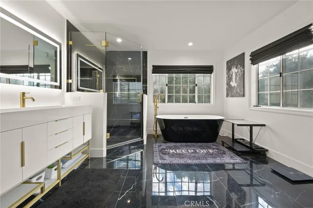 a kitchen with stainless steel appliances kitchen island granite countertop a refrigerator and cabinets