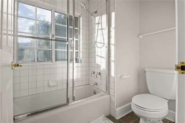 a spacious bedroom with a bed and wooden floor