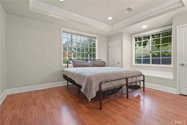 a bedroom with a large bed and a large window