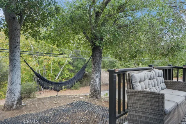 a front view of a house with a yard and mountain view in back