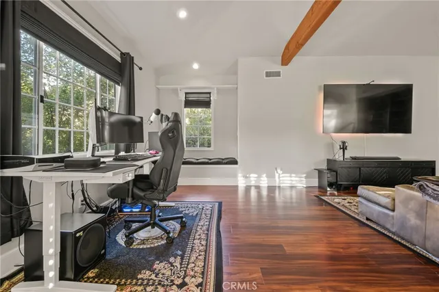 a living room with furniture a rug and a flat screen tv