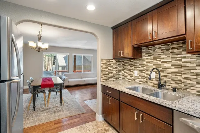a kitchen with stainless steel appliances granite countertop a sink and cabinets