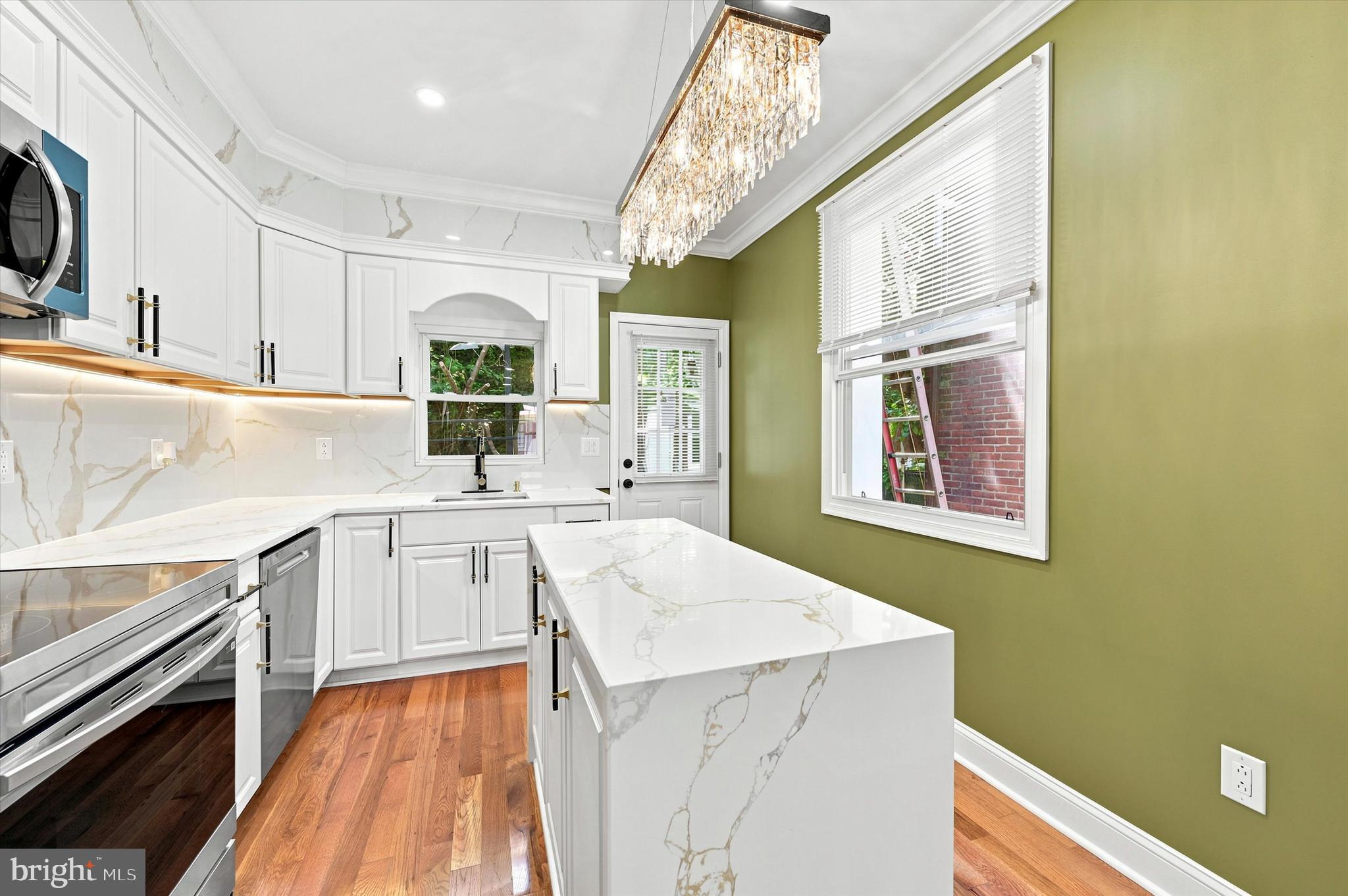 1620 South Yewdall Street Philadelphia, PA 19143 - Photo 13 of 38 a kitchen with a sink stove and microwave