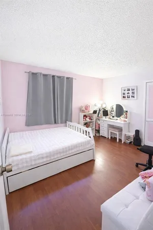 a bedroom with furniture and a large window