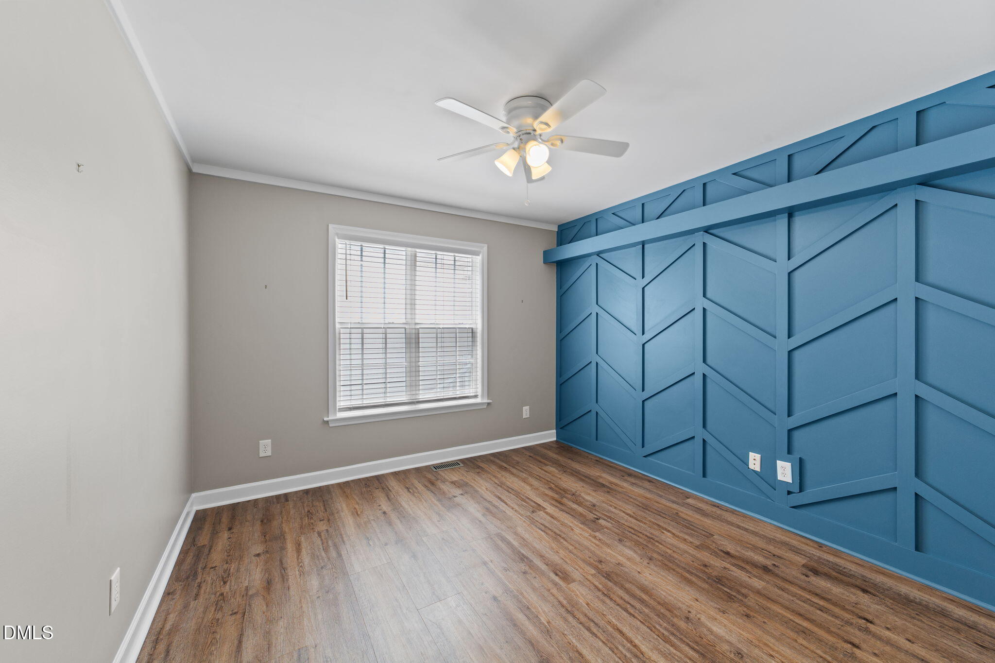 6820 Oviedo Drive Raleigh, NC 27603 - Photo 29 of 50 a view of an empty room with wooden floor and a window