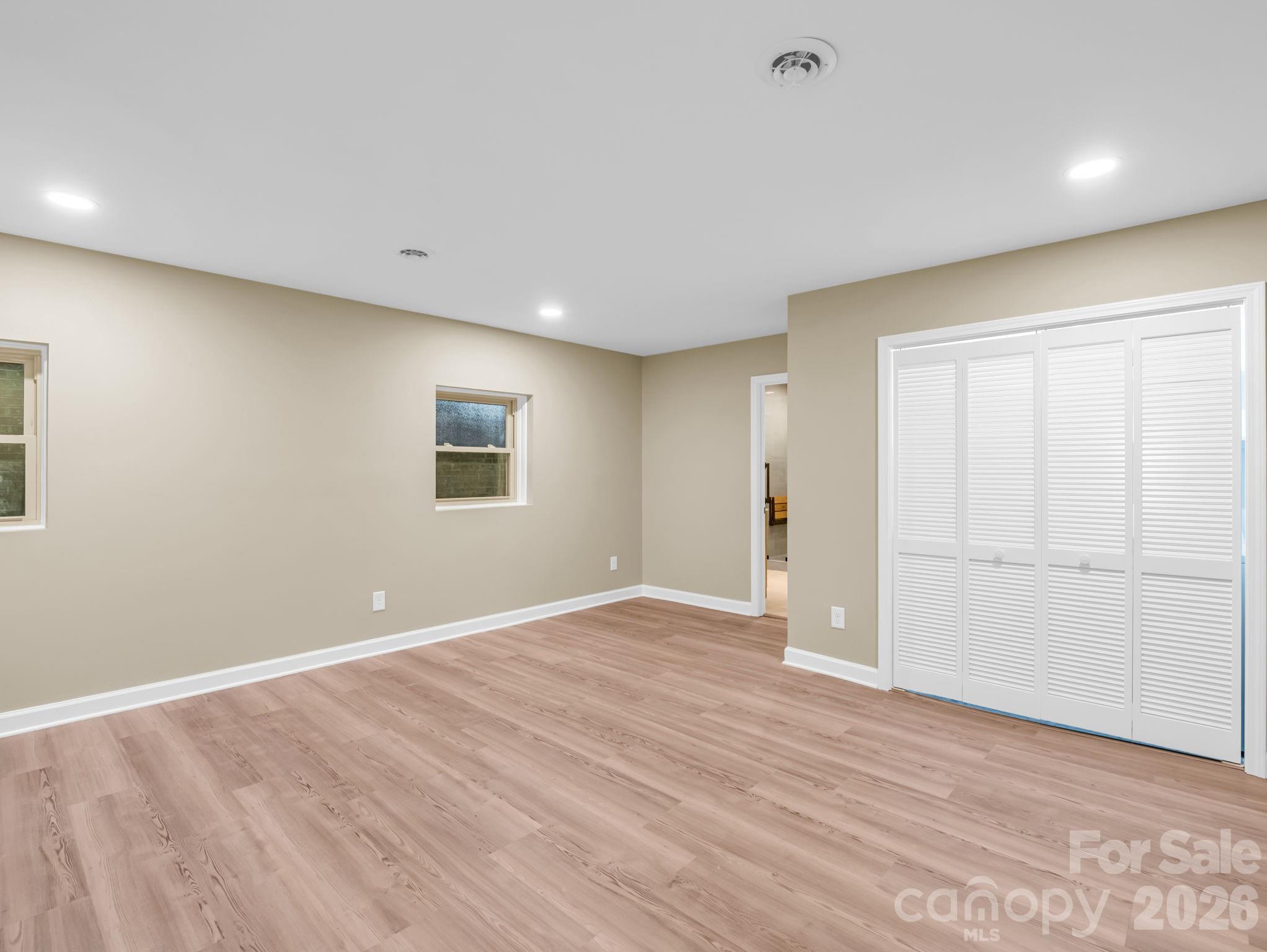 44 Jervey Road, Unit 4C Tryon, NC 28782 - Photo 16 of 35 a view of an empty room with wooden floor and a window