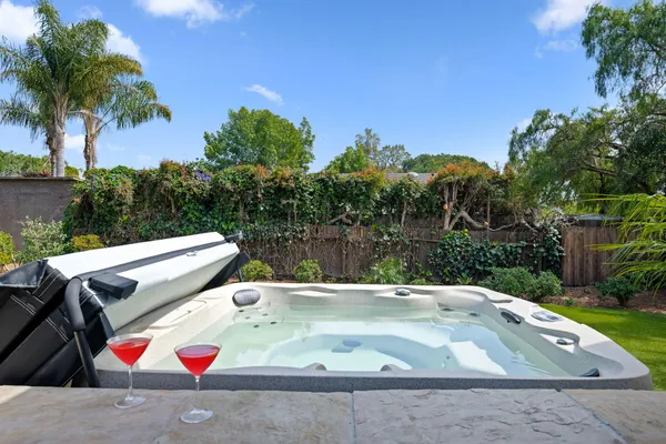 a view of backyard with swimming pool and outdoor seating