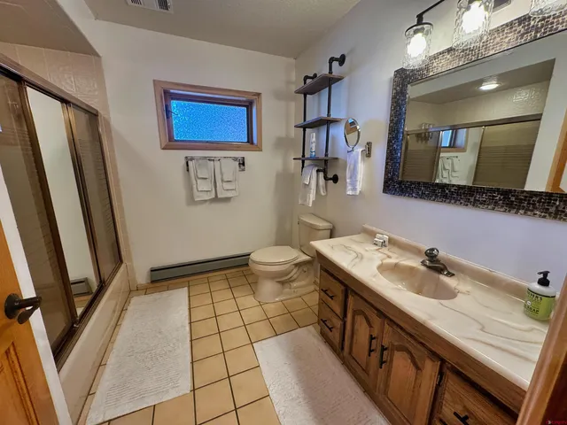 a bathroom with a sink a toilet and mirror
