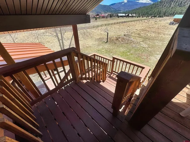 a view of balcony with wooden floor
