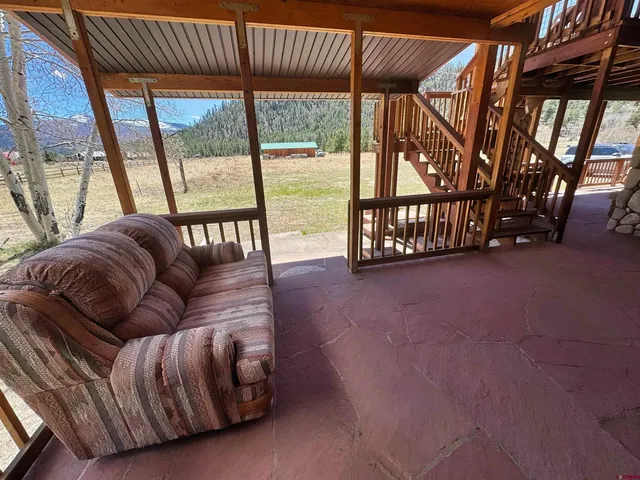 a living room with furniture and a floor to ceiling window