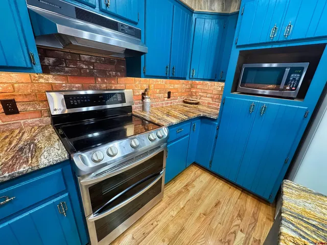 a kitchen with wooden cabinets and a stove top oven
