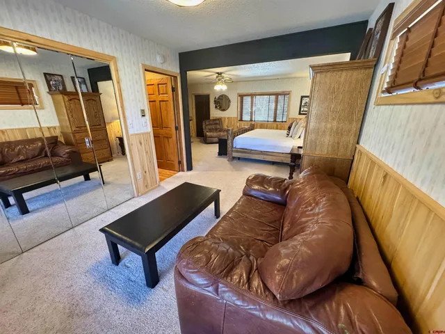 a living room with furniture and a mirror