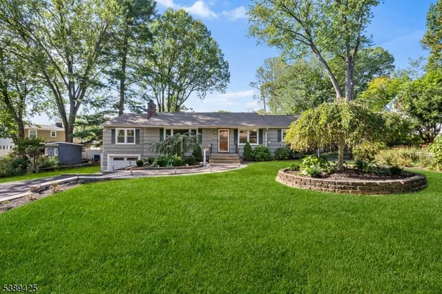 a view of a house with a yard table and chairs