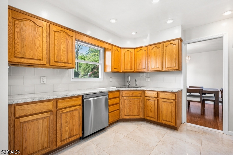 333 Old Tote Road Mountainside, NJ 07092 - Photo 13 of 48 a kitchen with granite countertop cabinets stainless steel appliances a sink and a window