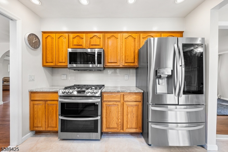 333 Old Tote Road Mountainside, NJ 07092 - Photo 14 of 48 a kitchen with stainless steel appliances a stove and a microwave