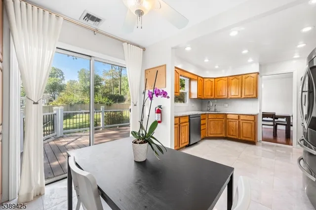 a kitchen with stainless steel appliances granite countertop a sink a stove and a refrigerator