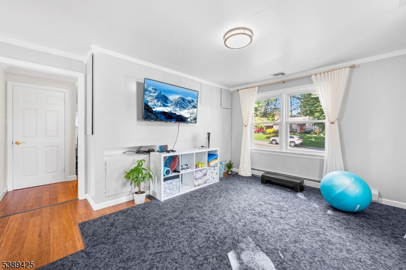 333 Old Tote Road Mountainside, NJ 07092 - Photo 20 of 48 a living room with furniture and a flat screen tv