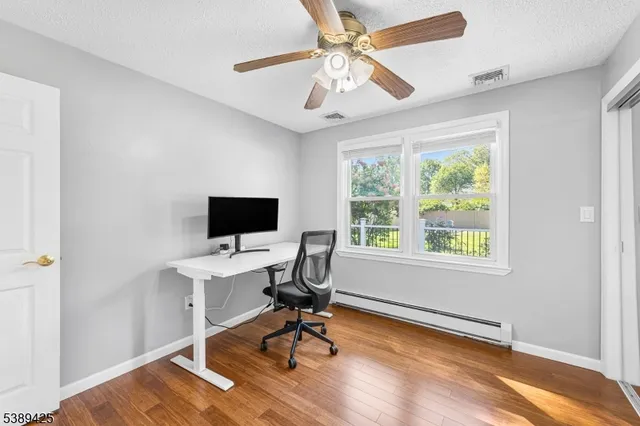 a workspace with wooden floor and a window