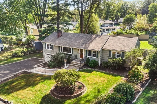 front view of house with a yard and swimming pool