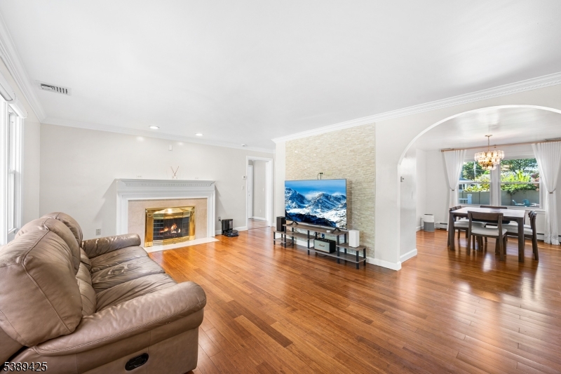 333 Old Tote Road Mountainside, NJ 07092 - Photo 5 of 48 a living room with furniture a fireplace and a flat screen tv