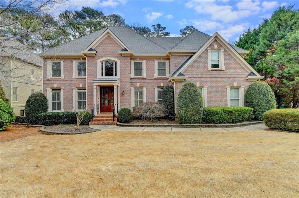 a front view of a house with a yard