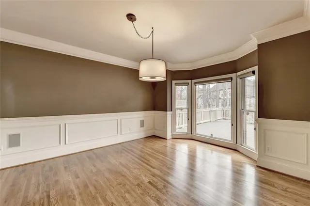a dining room with furniture and wooden floor