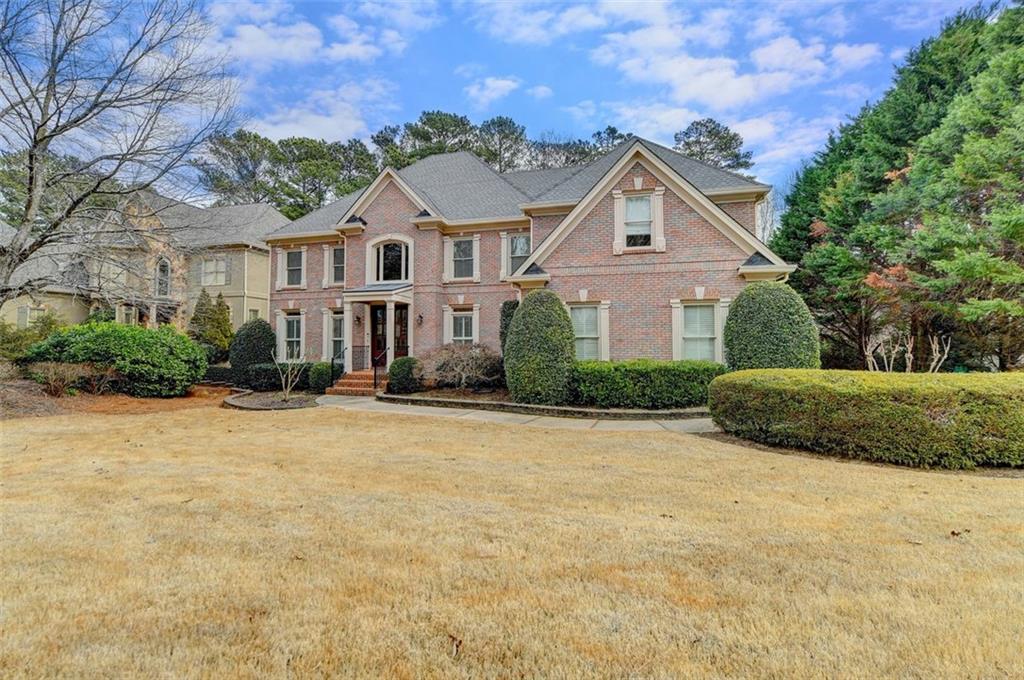 7830 Tintern Trace Duluth, GA 30097 - Photo 2 of 91 a front view of a house with a yard and garage