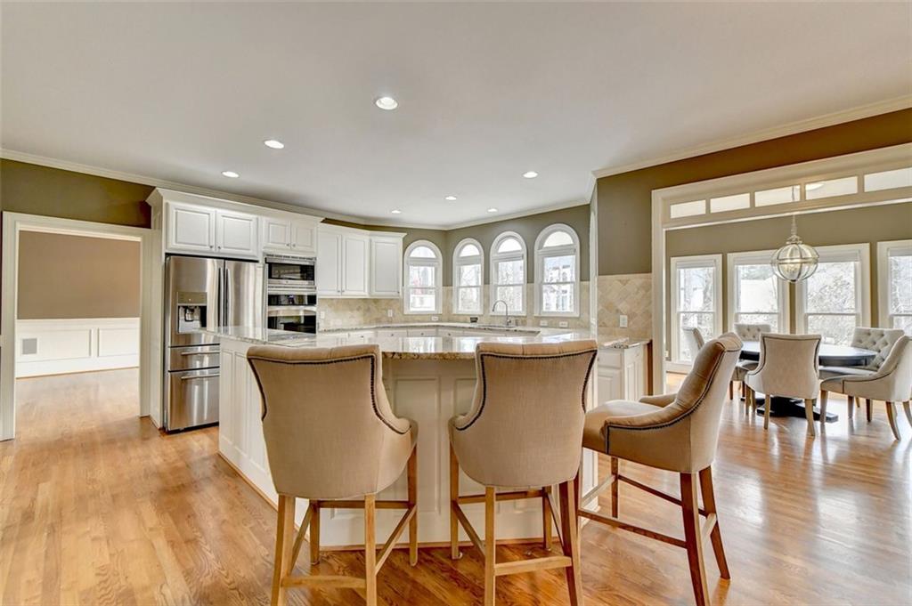 7830 Tintern Trace Duluth, GA 30097 - Photo 23 of 91 a dining room with furniture and wooden floor
