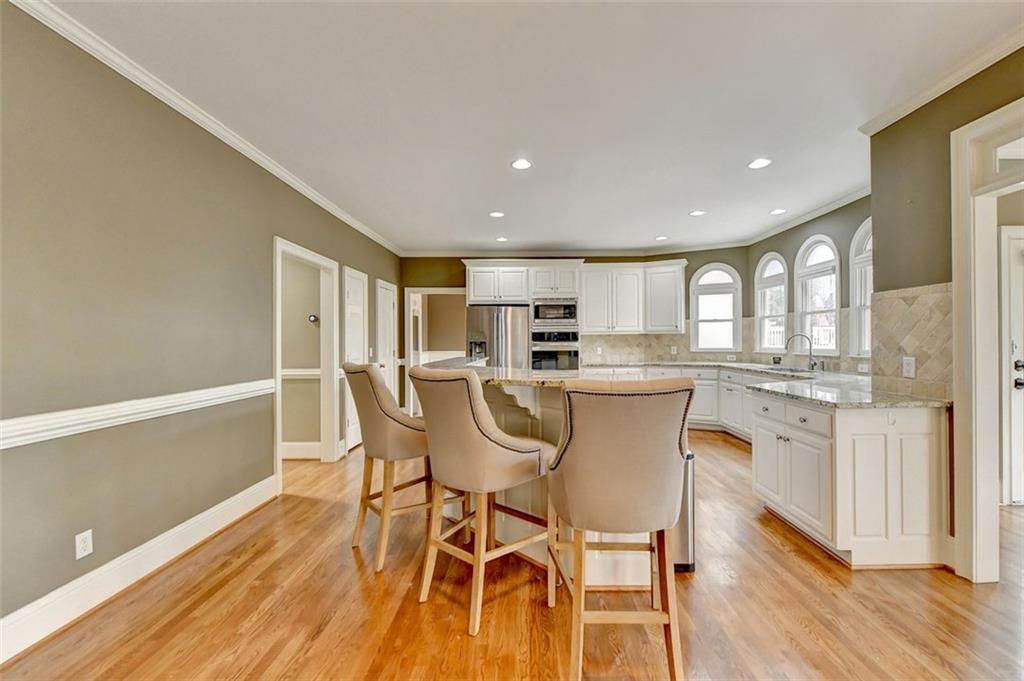 7830 Tintern Trace Duluth, GA 30097 - Photo 24 of 91 a view of a dining room with furniture a rug and wooden floor