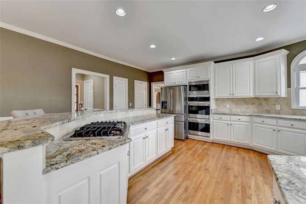 7830 Tintern Trace Duluth, GA 30097 - Photo 28 of 91 a kitchen with stainless steel appliances granite countertop a stove and a sink