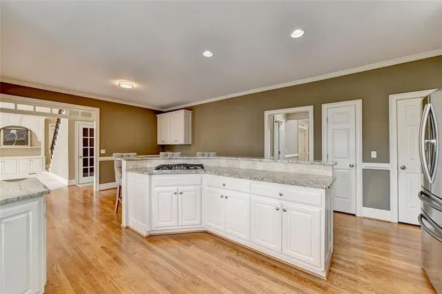 a bathroom with a granite countertop sink a light fixture and a mirror