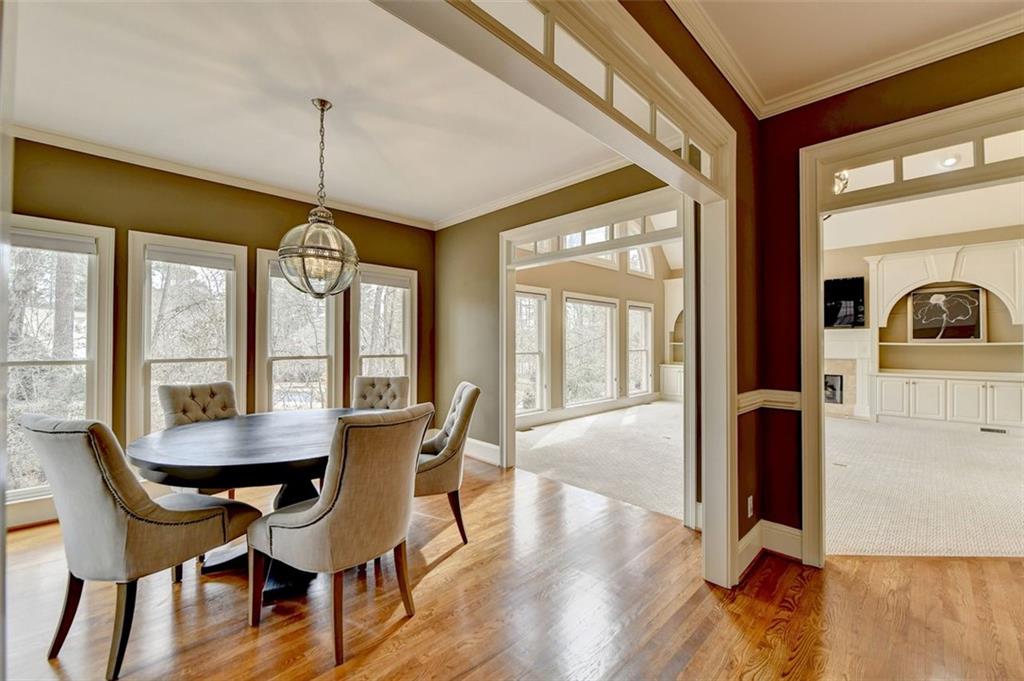 7830 Tintern Trace Duluth, GA 30097 - Photo 33 of 91 a view of a dining room with furniture window and wooden floor