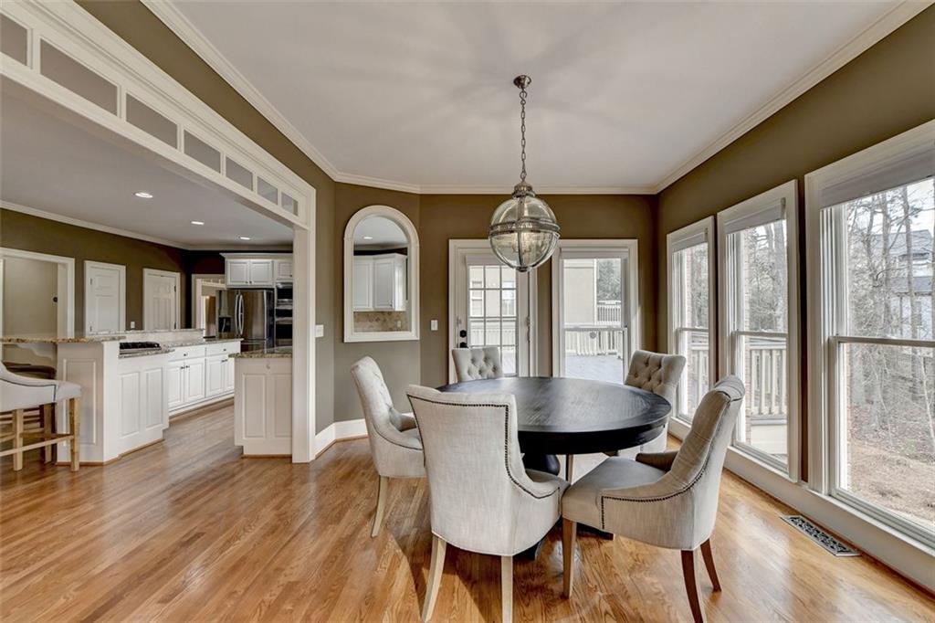 7830 Tintern Trace Duluth, GA 30097 - Photo 35 of 91 a view of a dining room with furniture window and wooden floor