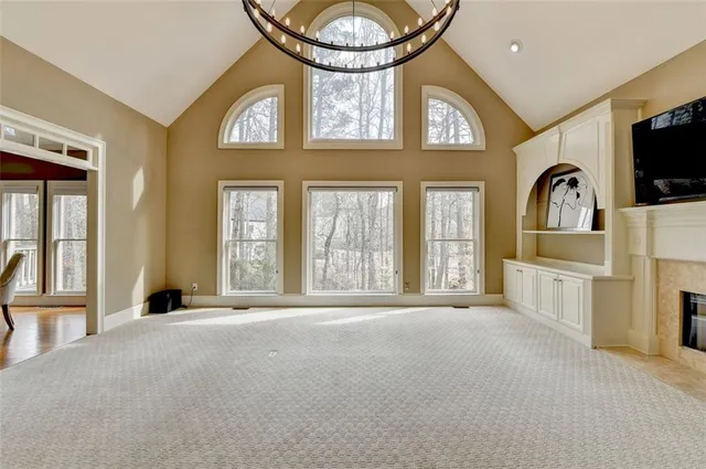 a view of an empty room with a window and storage