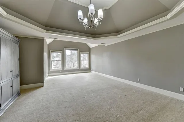 a kitchen with stainless steel appliances kitchen island granite countertop a table chairs in it and wooden floors