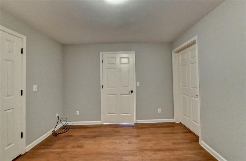 7830 Tintern Trace Duluth, GA 30097 - Photo 80 of 91 a view of an empty room with wooden floor and closet