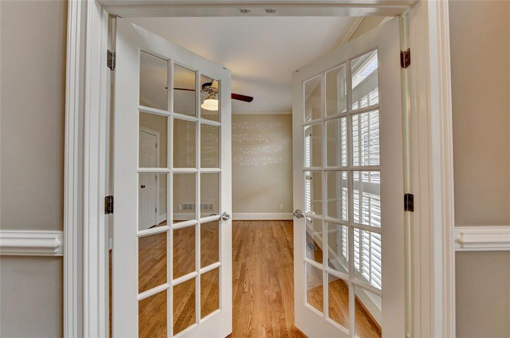 7830 Tintern Trace Duluth, GA 30097 - Photo 8 of 91 a view of an empty room with wooden floor and windows