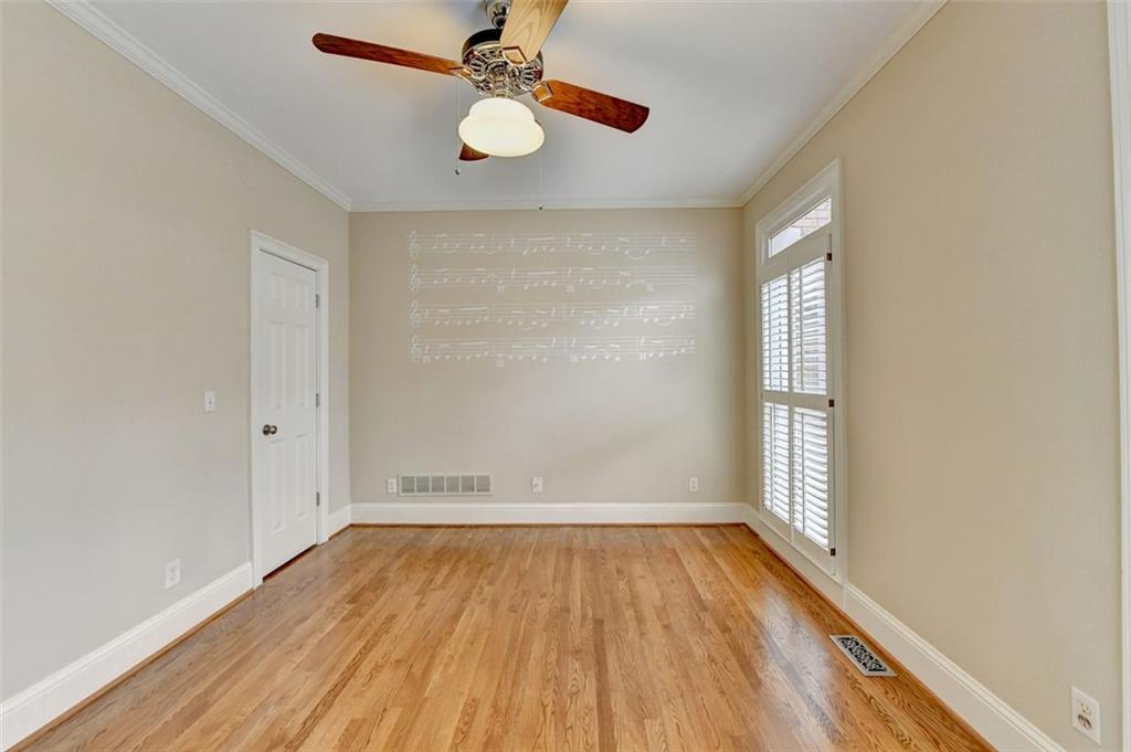 7830 Tintern Trace Duluth, GA 30097 - Photo 9 of 91 an empty room with wooden floor fan and windows