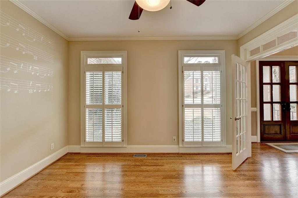 7830 Tintern Trace Duluth, GA 30097 - Photo 10 of 91 a view of an empty room with wooden floor and a window