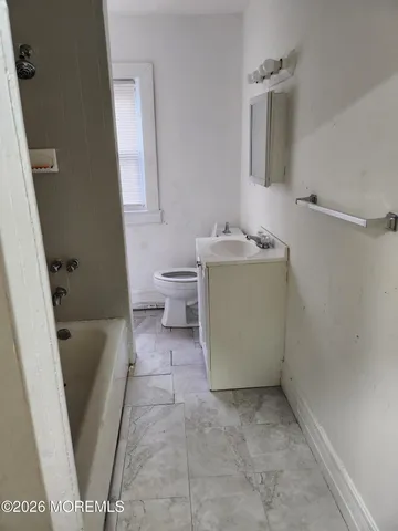a bathroom with a sink a toilet and bathtub
