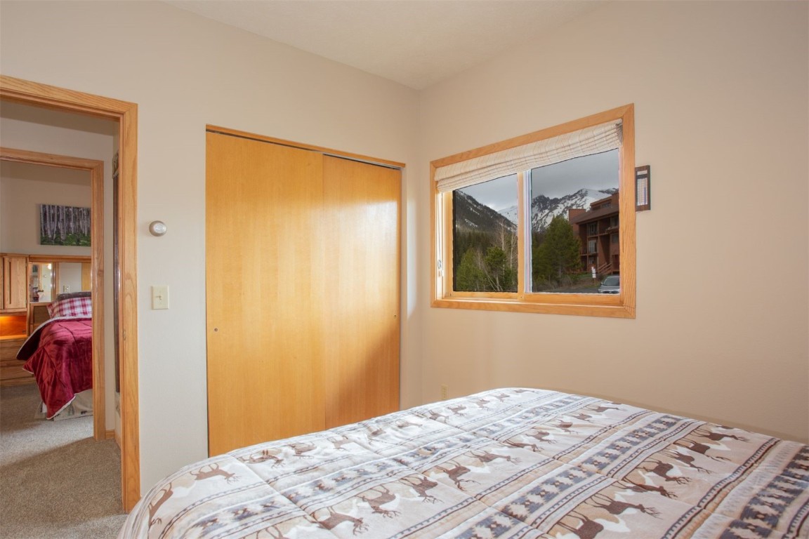 91400 Ryan Gulch Road, Unit 419 Silverthorne, CO 80498 - Photo 15 of 34 a bedroom with a bed and a window