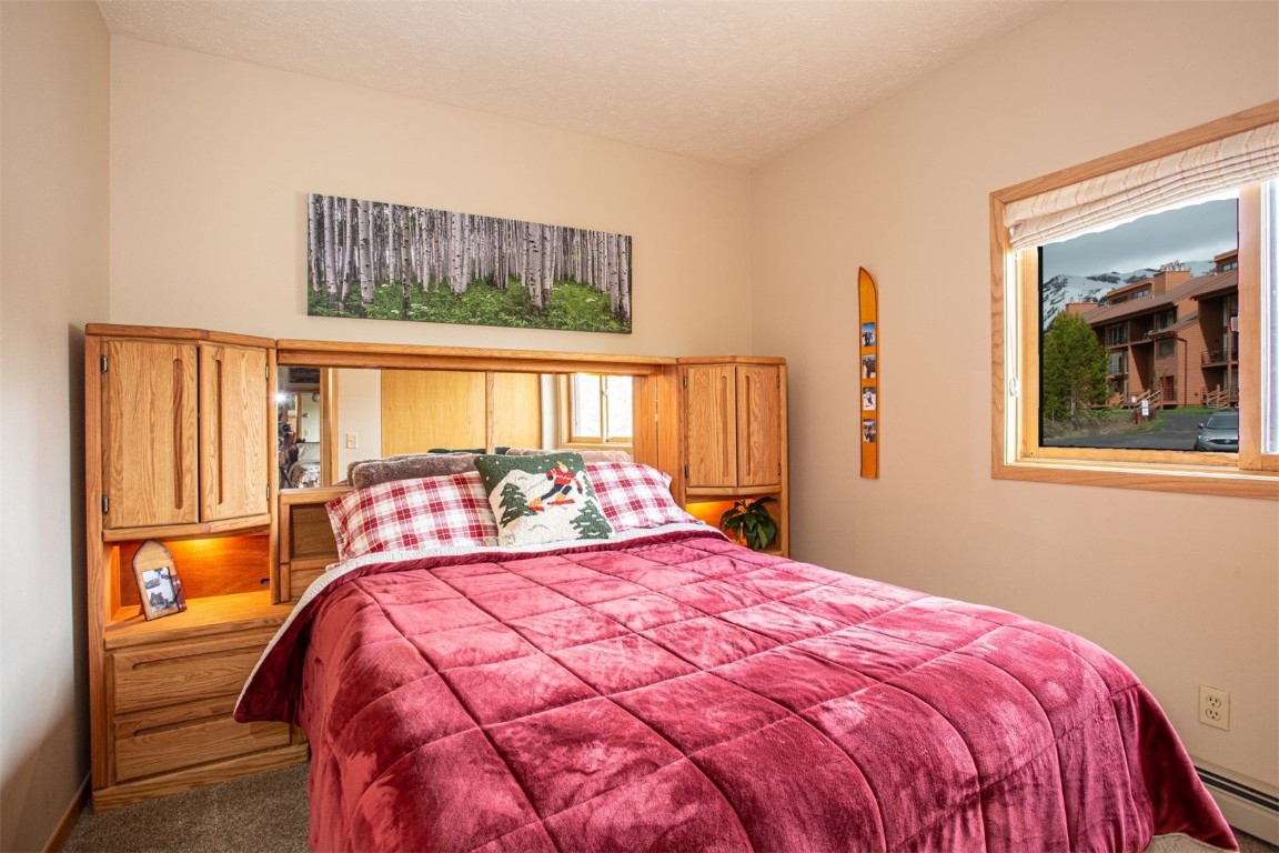 91400 Ryan Gulch Road, Unit 419 Silverthorne, CO 80498 - Photo 20 of 34 a bedroom with a large bed and a window