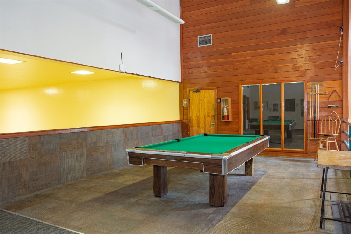 91400 Ryan Gulch Road, Unit 419 Silverthorne, CO 80498 - Photo 25 of 34 a room with pool table and windows