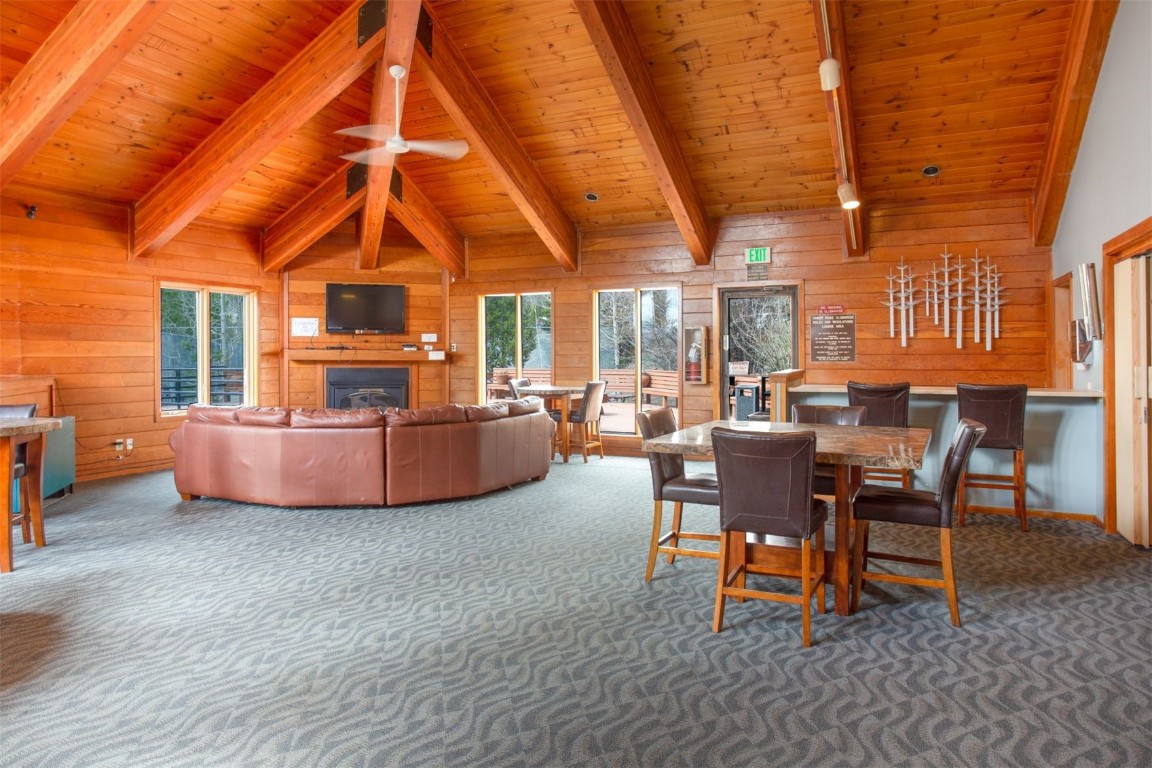 91400 Ryan Gulch Road, Unit 419 Silverthorne, CO 80498 - Photo 27 of 34 a living room with furniture a dining table and chairs