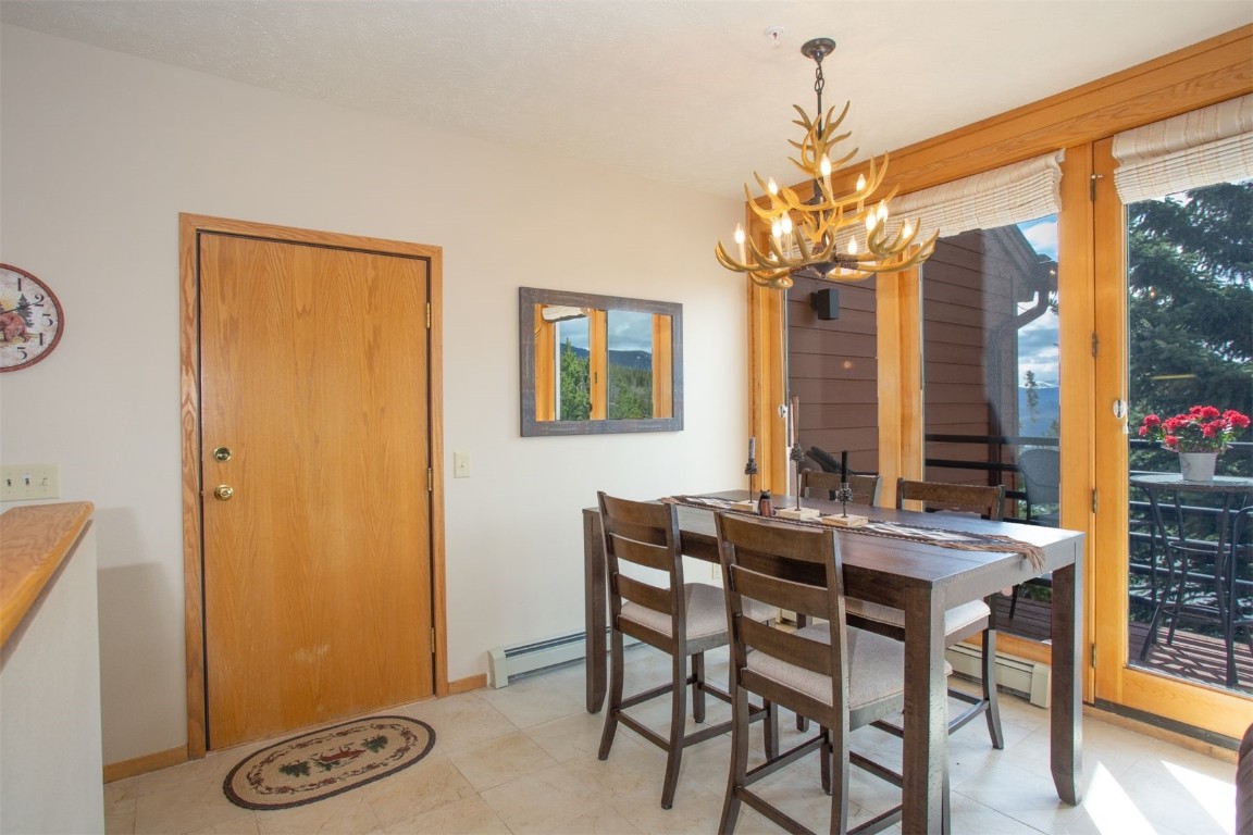 91400 Ryan Gulch Road, Unit 419 Silverthorne, CO 80498 - Photo 5 of 34 a view of a dining room with furniture window and outside view