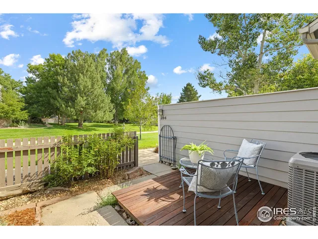 a view of a patio with table and chairs with wooden floor