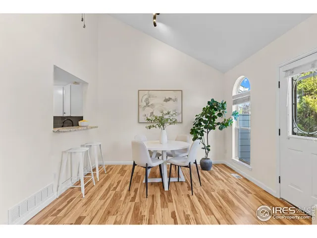 a view of a workspace with furniture window and wooden floor