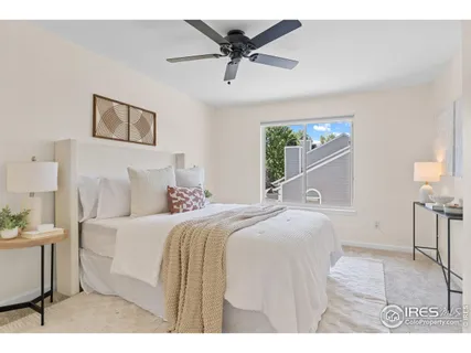 a spacious bedroom with a bed and a chandelier